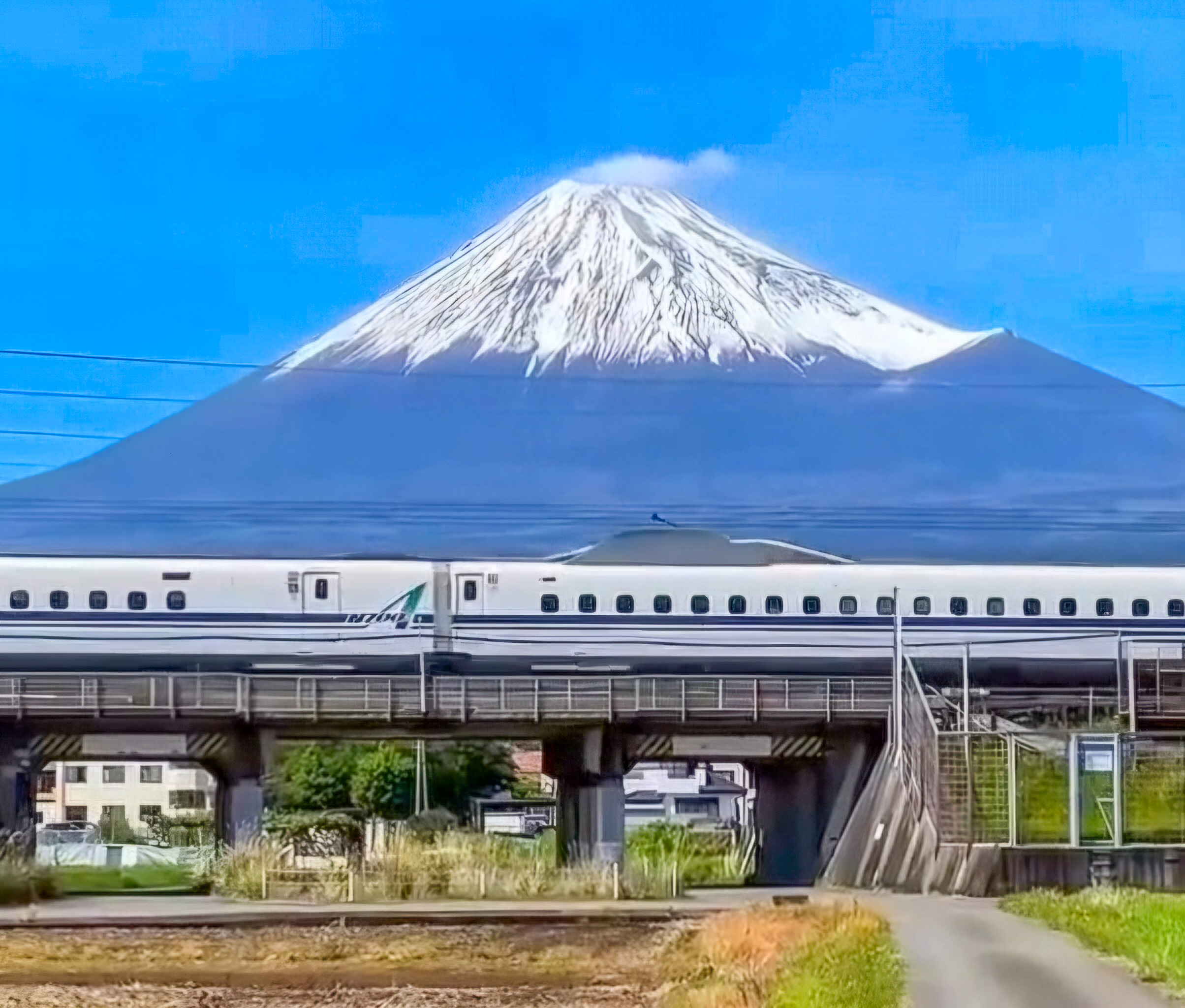 Shinkansen bullet train passing Mount Fuji in Japan