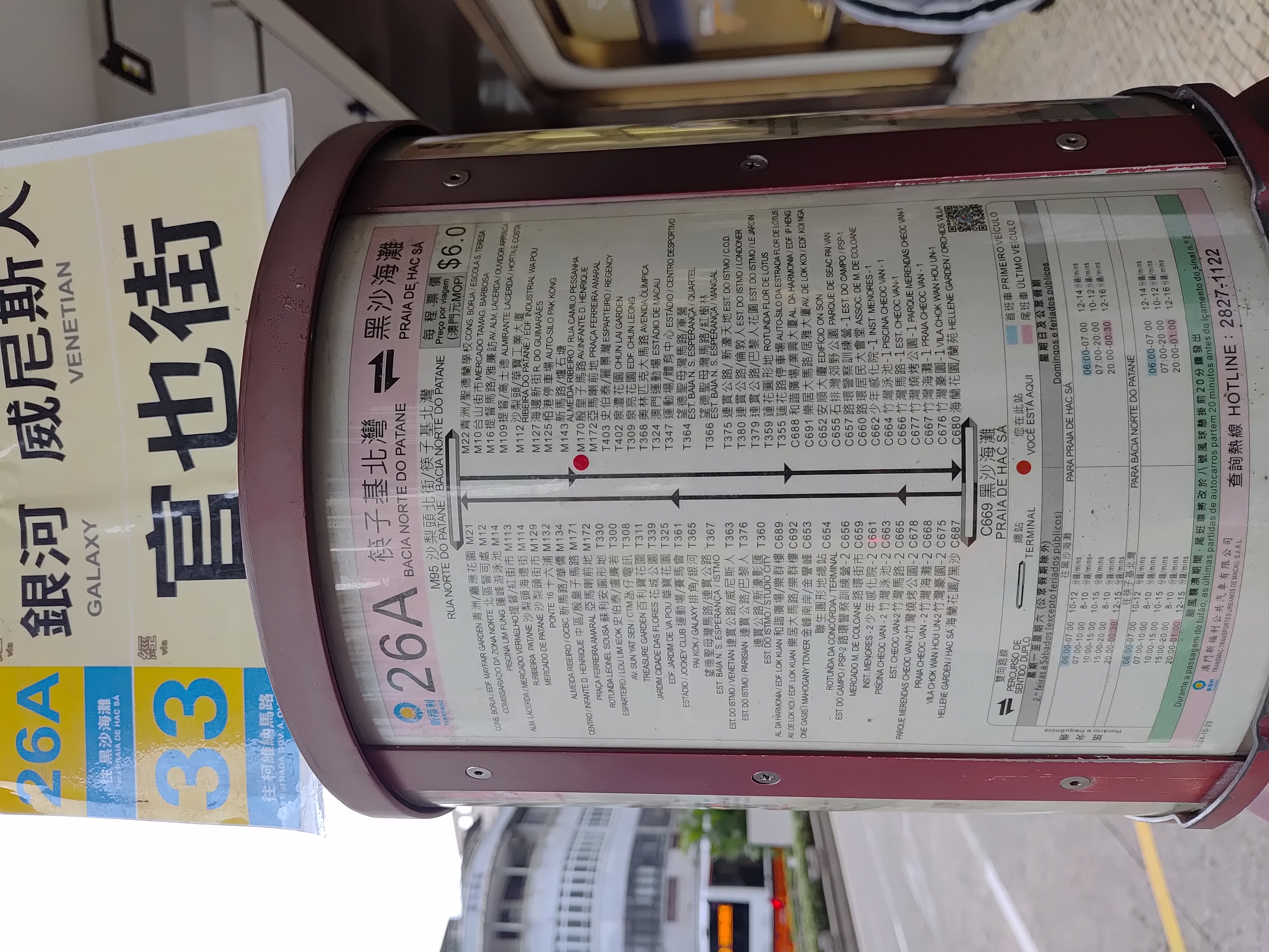 Posters detailing bus routes and stops at a Macau public bus station