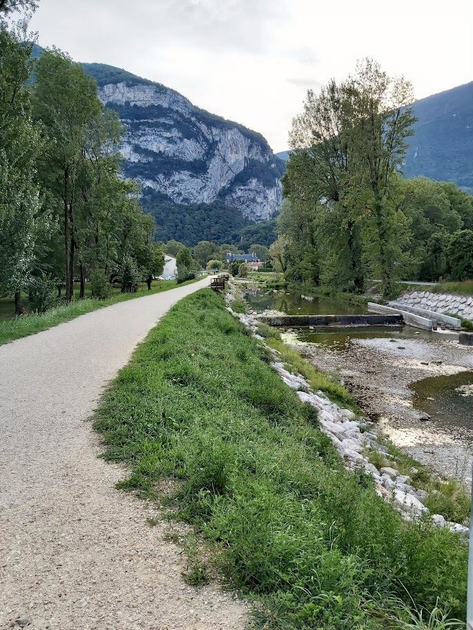 Traveler walking through stone archway in Annecy old town