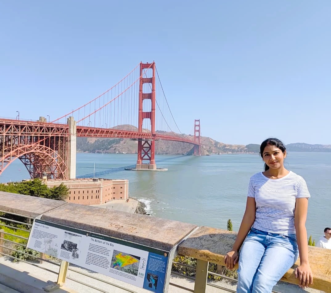 People walking through colorful Mission District alleyway